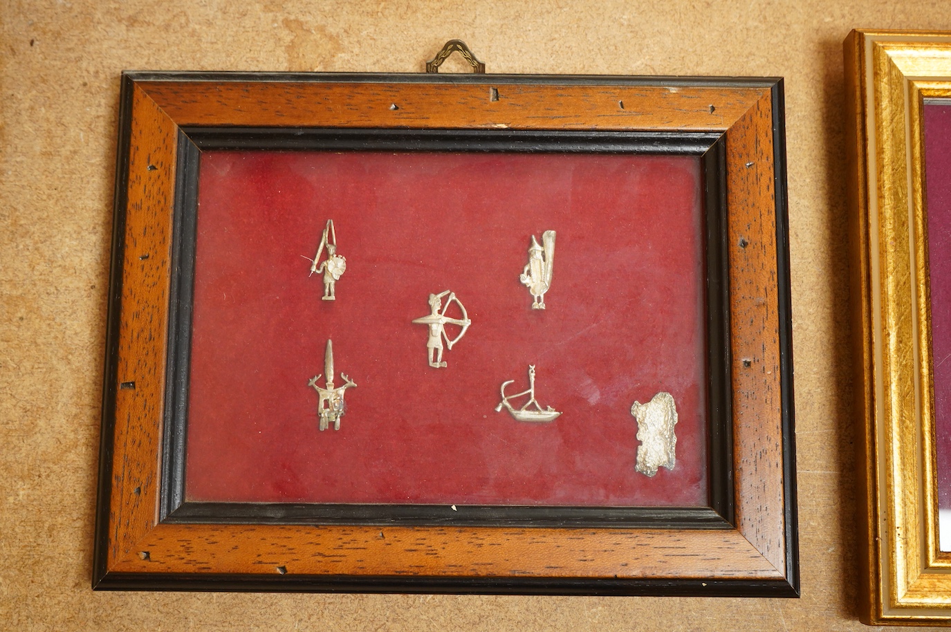 A Roman bronze badge, a medieval pewter badge and silver badges in the form of Sardinia emblems all framed., Swan badge 6cm wide, not including mount or frame. (Requires provenance)